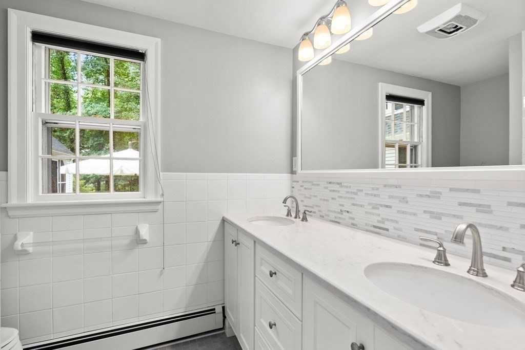 49 Sears Road Wayland, MA 01778 - Photo 16 of 30 a bathroom with a double vanity sink window and a mirror