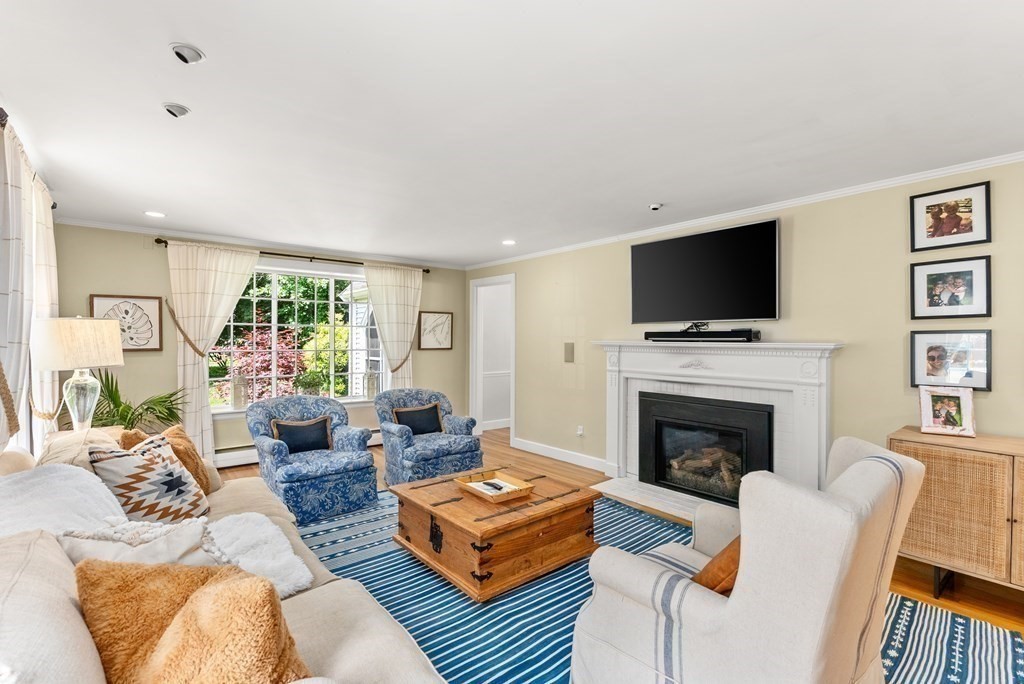 49 Sears Road Wayland, MA 01778 - Photo 4 of 30 a living room with furniture a flat screen tv and a fireplace