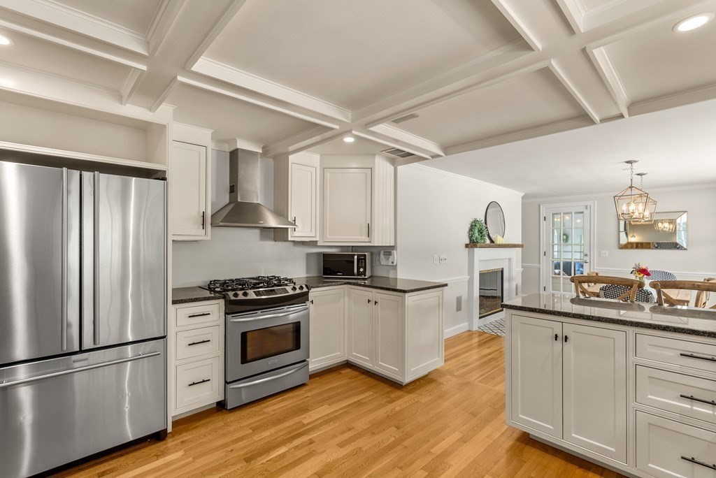 49 Sears Road Wayland, MA 01778 - Photo 5 of 30 a kitchen with white cabinets and stainless steel appliances