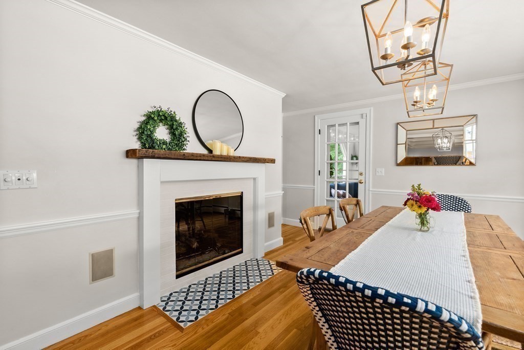 49 Sears Road Wayland, MA 01778 - Photo 10 of 30 a living room with furniture a fireplace and wall paintings