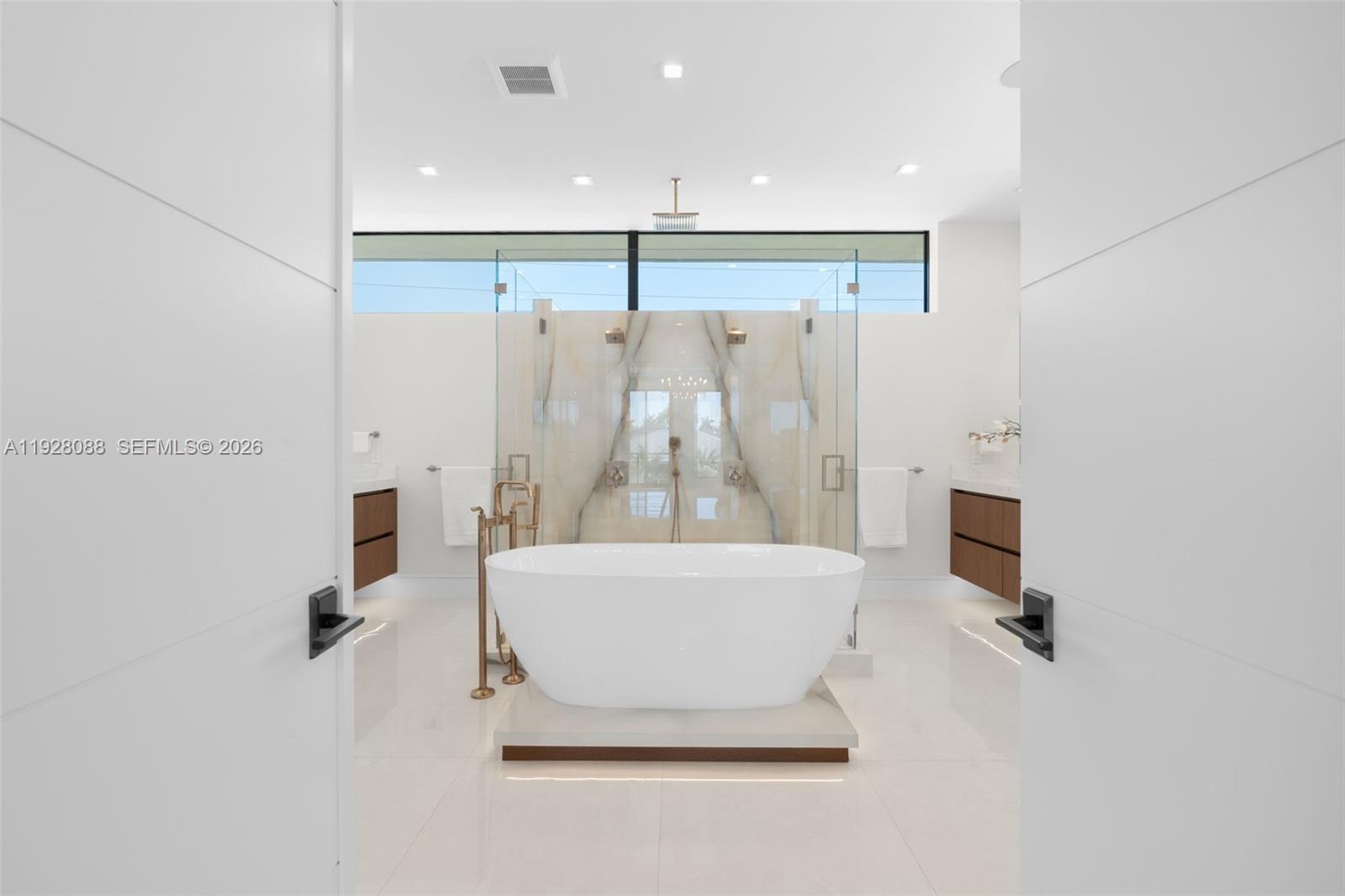4910 Northeast 27th Avenue Lighthouse Point, FL 33064 - Photo 36 of 68 a bathroom with a tub and a shower