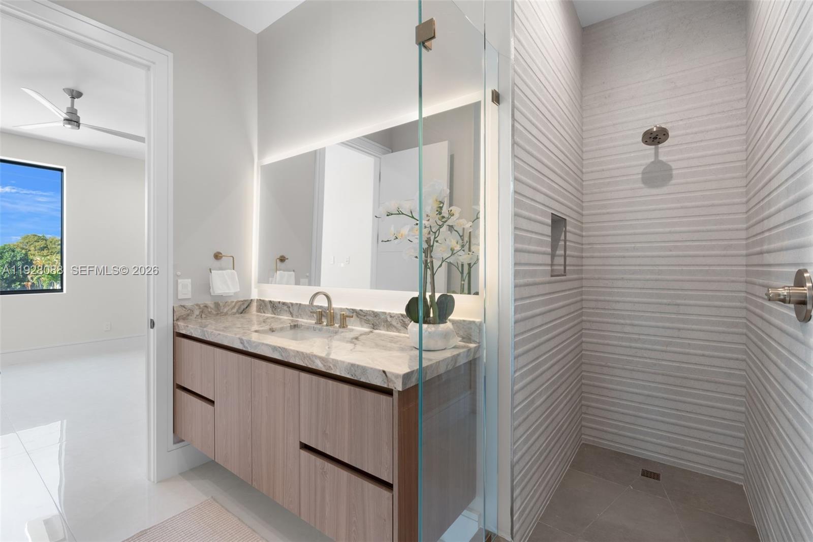4910 Northeast 27th Avenue Lighthouse Point, FL 33064 - Photo 48 of 68 a bathroom with a granite countertop sink and a mirror