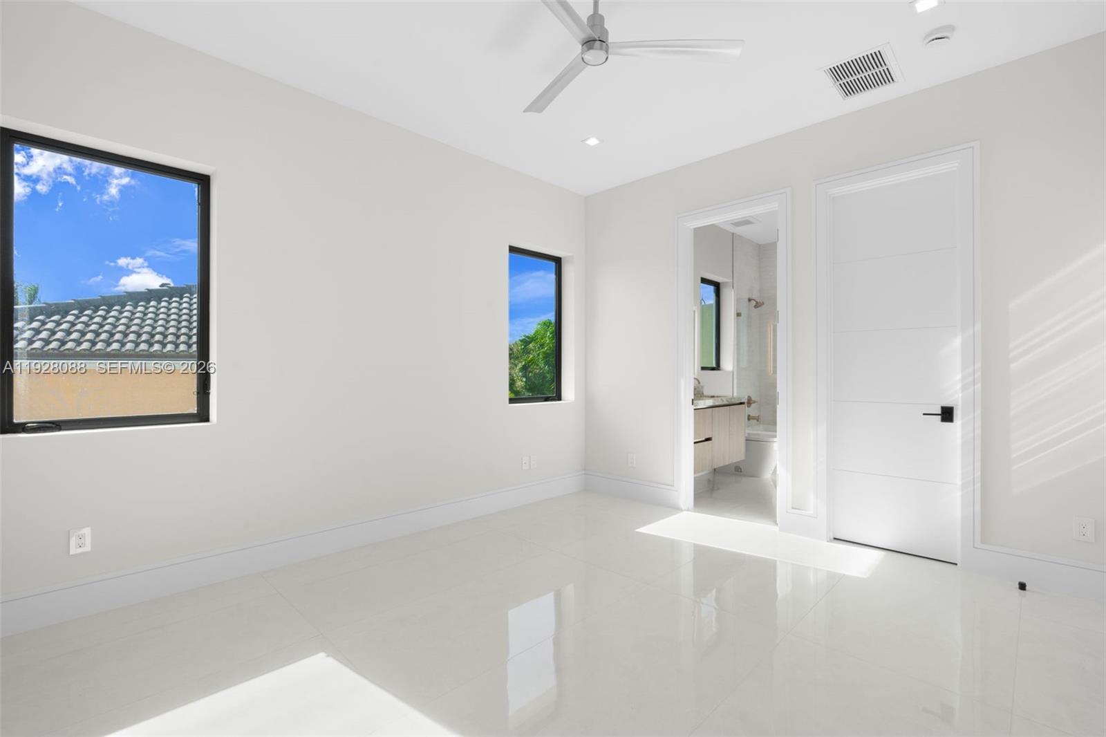 4910 Northeast 27th Avenue Lighthouse Point, FL 33064 - Photo 49 of 68 wooden floor in an empty room with a window