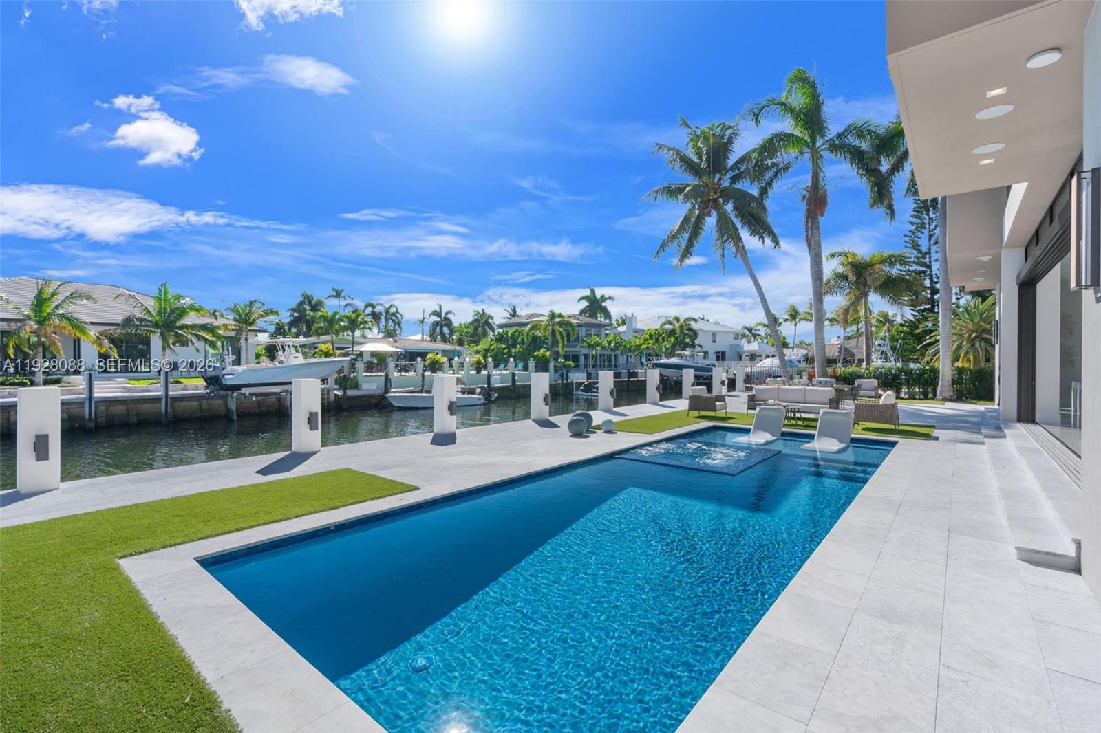 4910 Northeast 27th Avenue Lighthouse Point, FL 33064 - Photo 54 of 68 a view of a swimming pool with lounge chairs