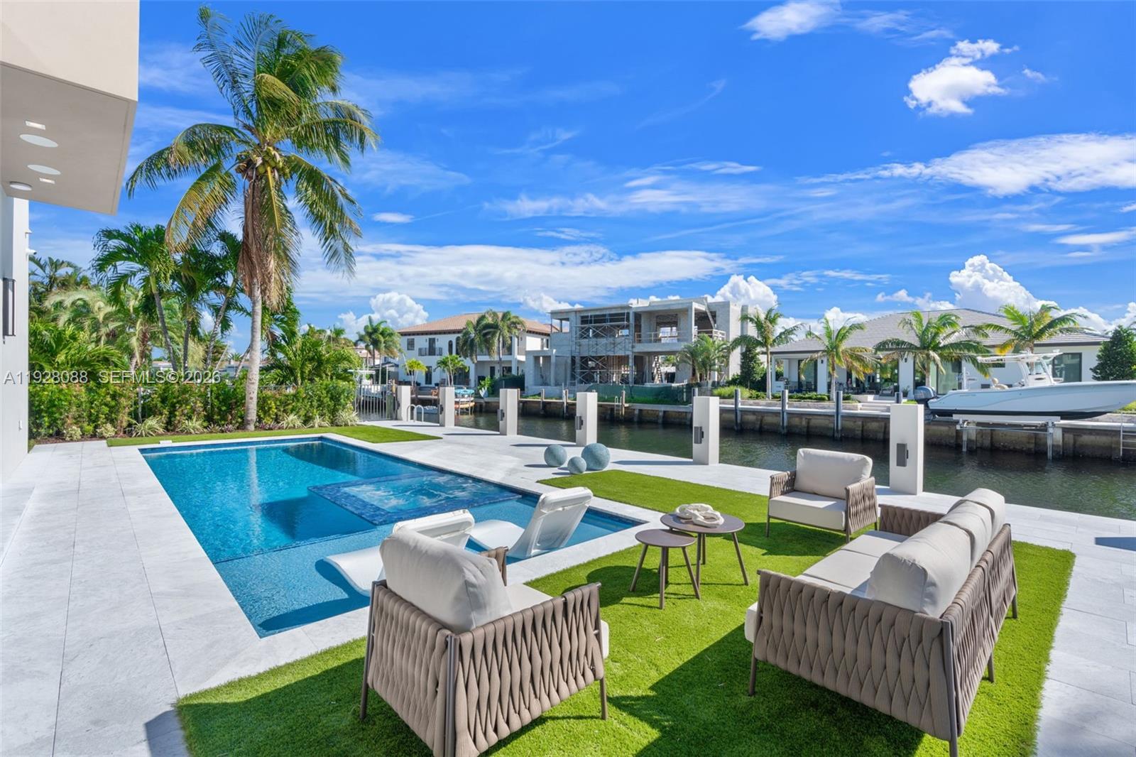 4910 Northeast 27th Avenue Lighthouse Point, FL 33064 - Photo 55 of 68 a view of a patio with couches table and chairs and potted plants
