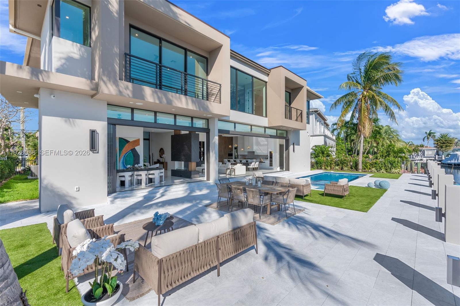 4910 Northeast 27th Avenue Lighthouse Point, FL 33064 - Photo 57 of 68 a view of a swimming pool with outdoor seating