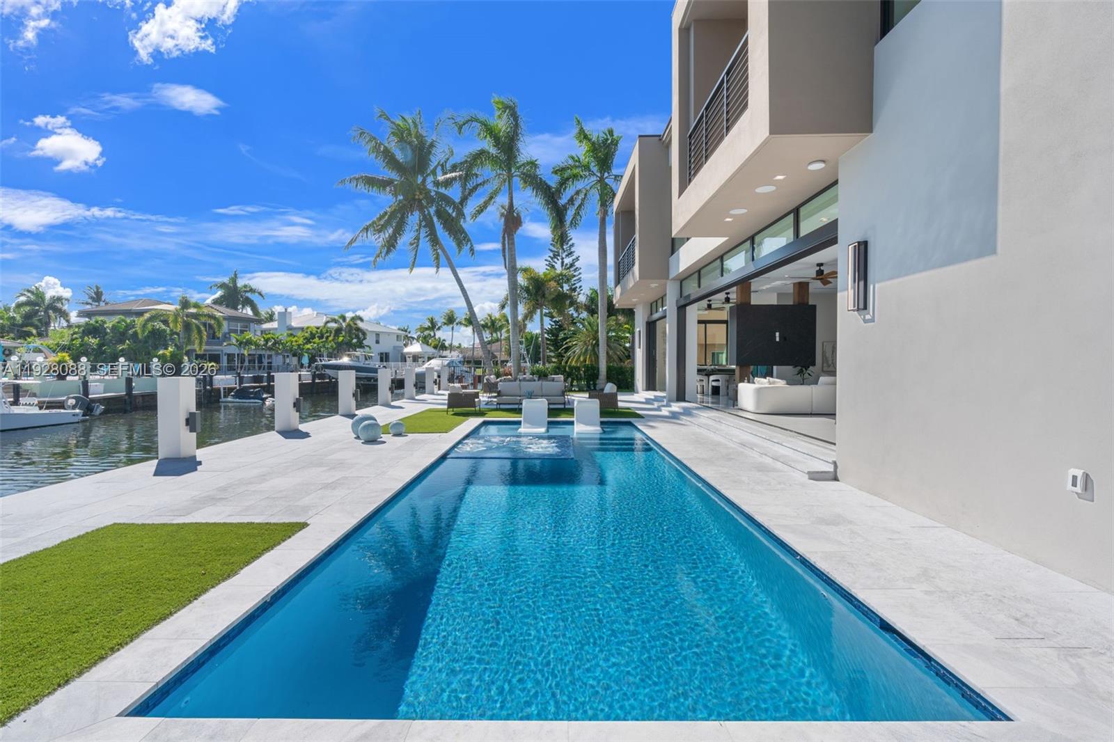 4910 Northeast 27th Avenue Lighthouse Point, FL 33064 - Photo 58 of 68 a view of swimming pool with outdoor seating