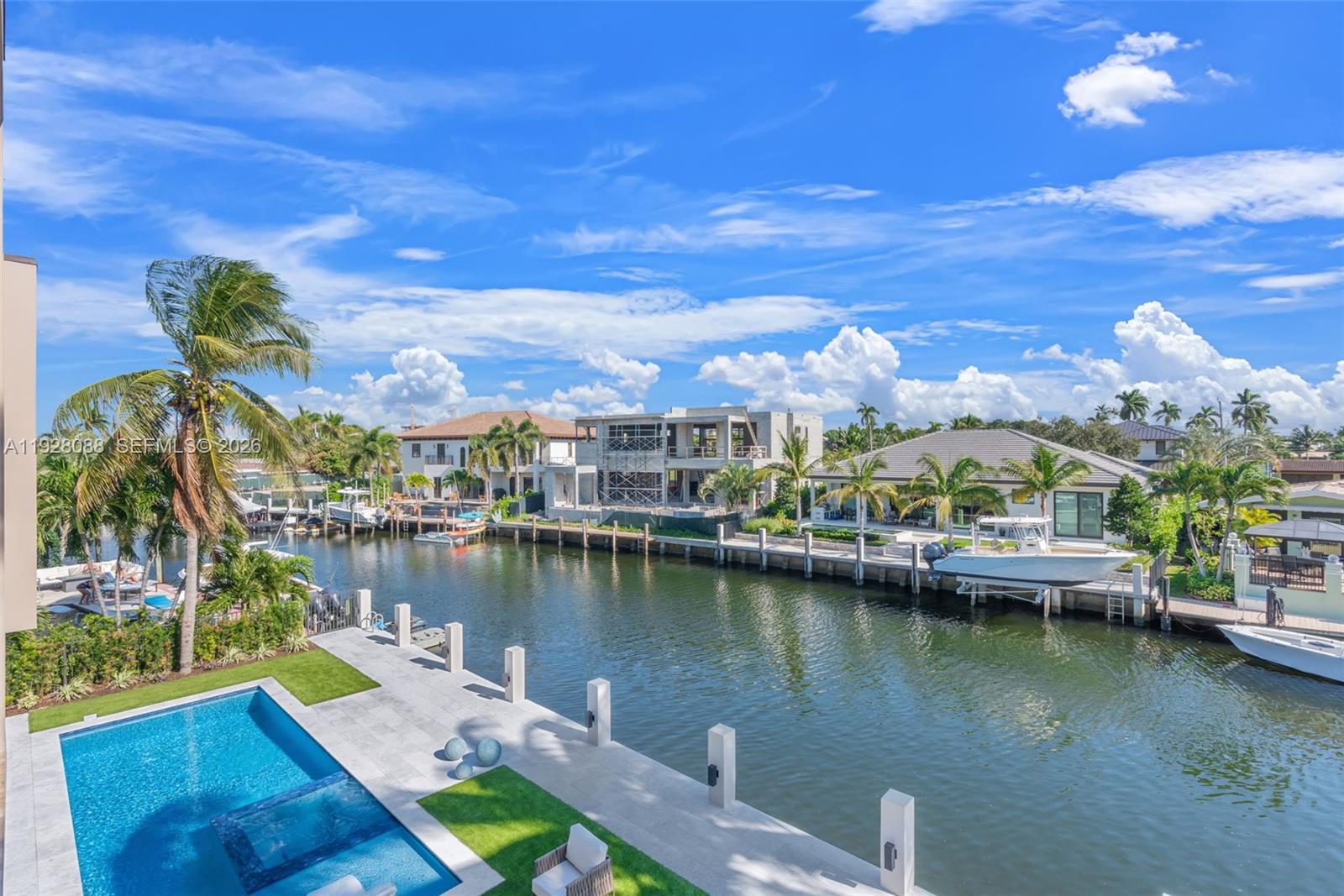 4910 Northeast 27th Avenue Lighthouse Point, FL 33064 - Photo 59 of 68 a view of a lake with lawn chairs and a table