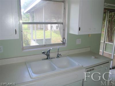 20 Colorado Road Lehigh Acres, FL 33936 - Photo 4 of 10 a bathroom with a sink and a window