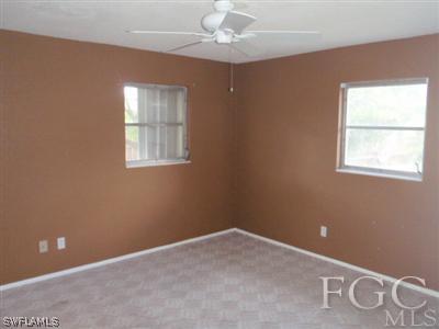 20 Colorado Road Lehigh Acres, FL 33936 - Photo 7 of 10 an empty room with windows and fan