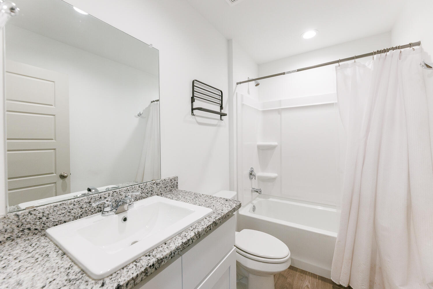 2305 150th Street Lubbock, TX 79423 - Photo 29 of 39 a bathroom with a granite countertop sink toilet and shower