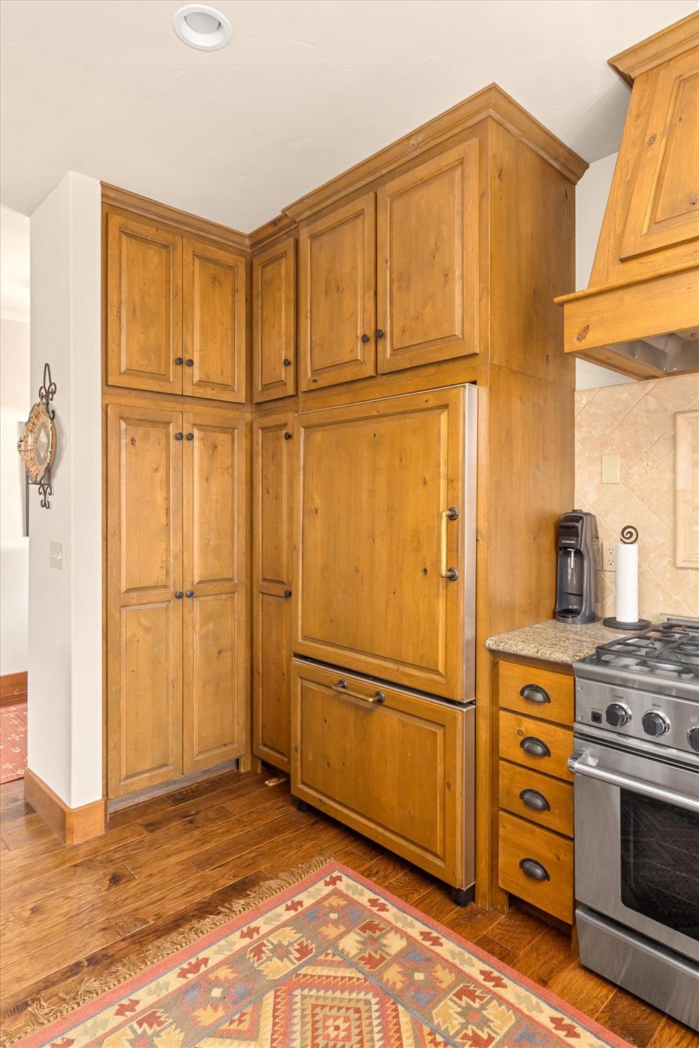110 Flynn Road Bear Valley, CA 95223 - Photo 18 of 56 a view of a refrigerator in kitchen with wooden floor