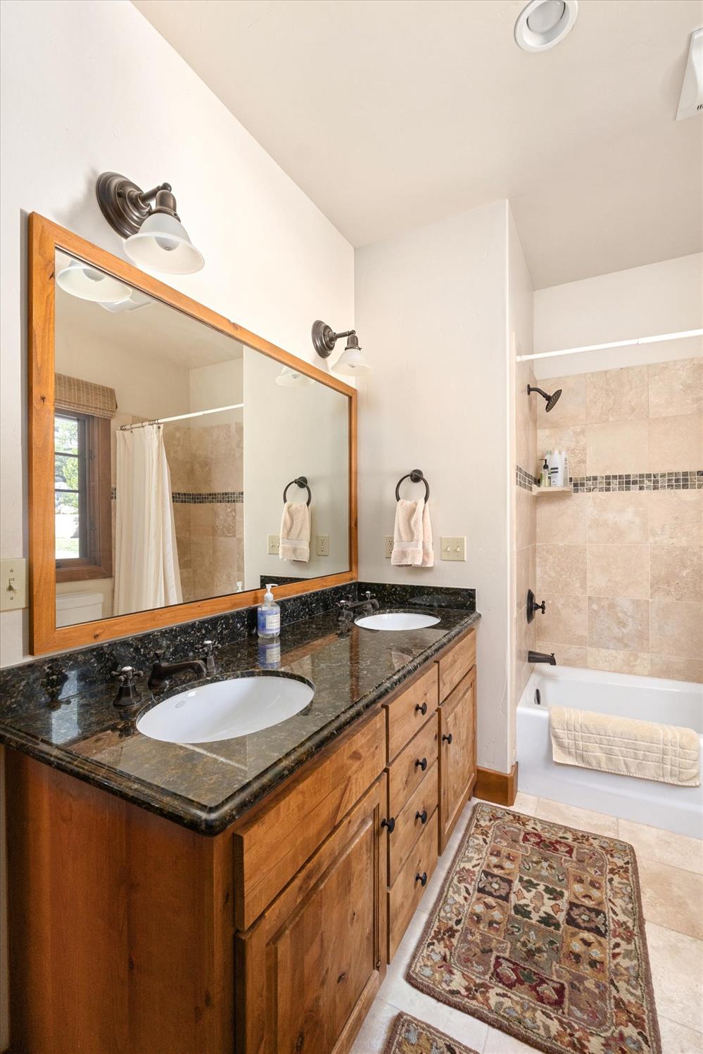 110 Flynn Road Bear Valley, CA 95223 - Photo 20 of 56 a bathroom with a granite countertop sink and a mirror
