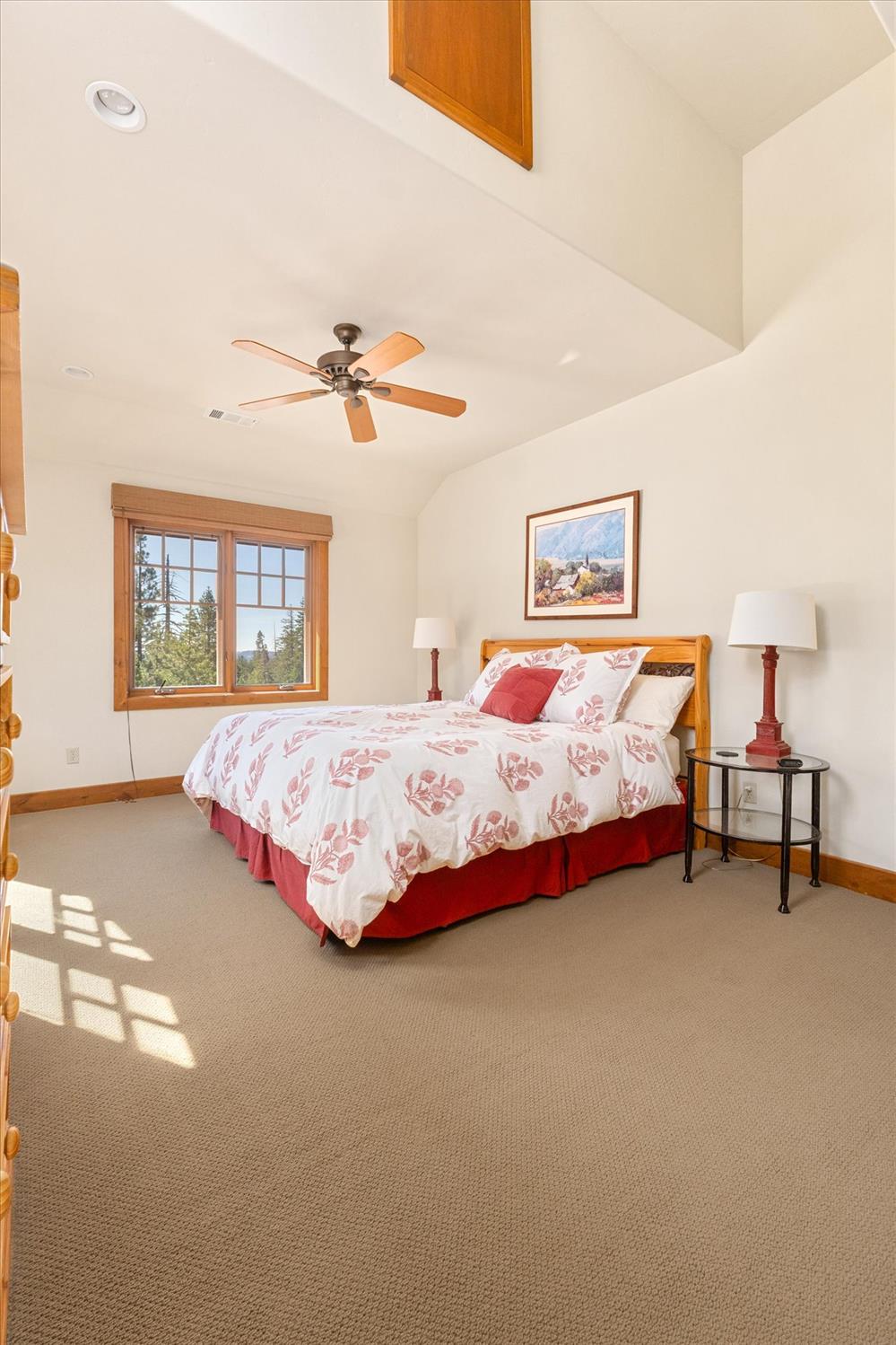 110 Flynn Road Bear Valley, CA 95223 - Photo 25 of 56 a bedroom with a bed and a chandelier