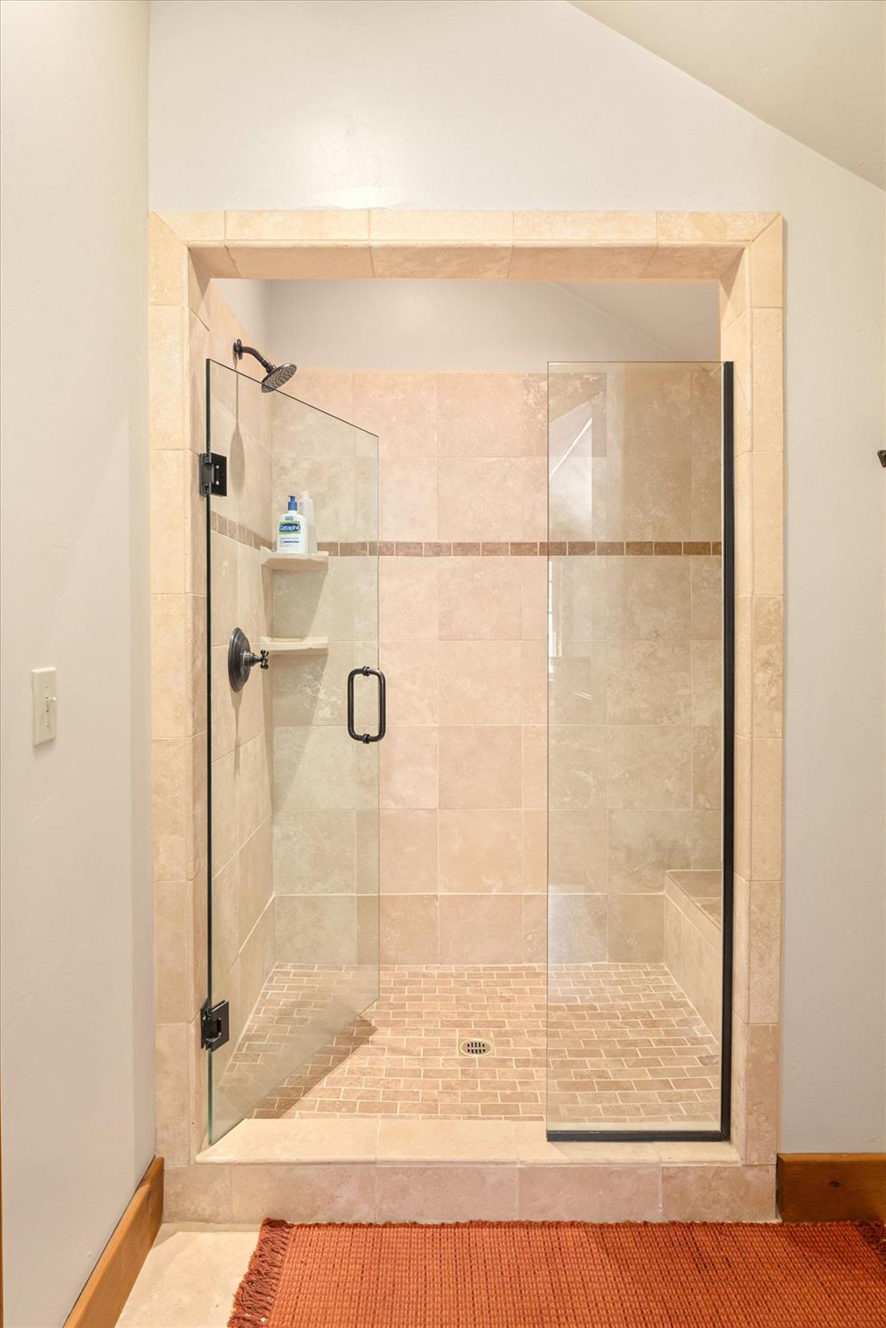 110 Flynn Road Bear Valley, CA 95223 - Photo 27 of 56 a bathroom with a glass shower door