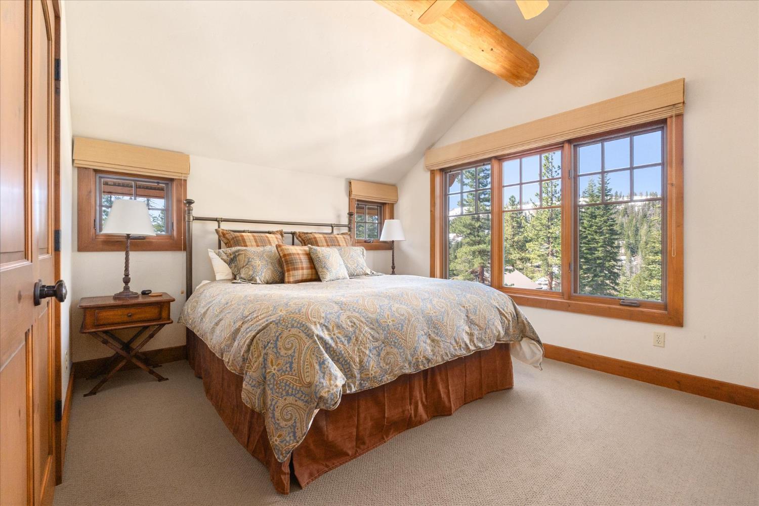 110 Flynn Road Bear Valley, CA 95223 - Photo 29 of 56 a spacious bedroom with a bed and a large window