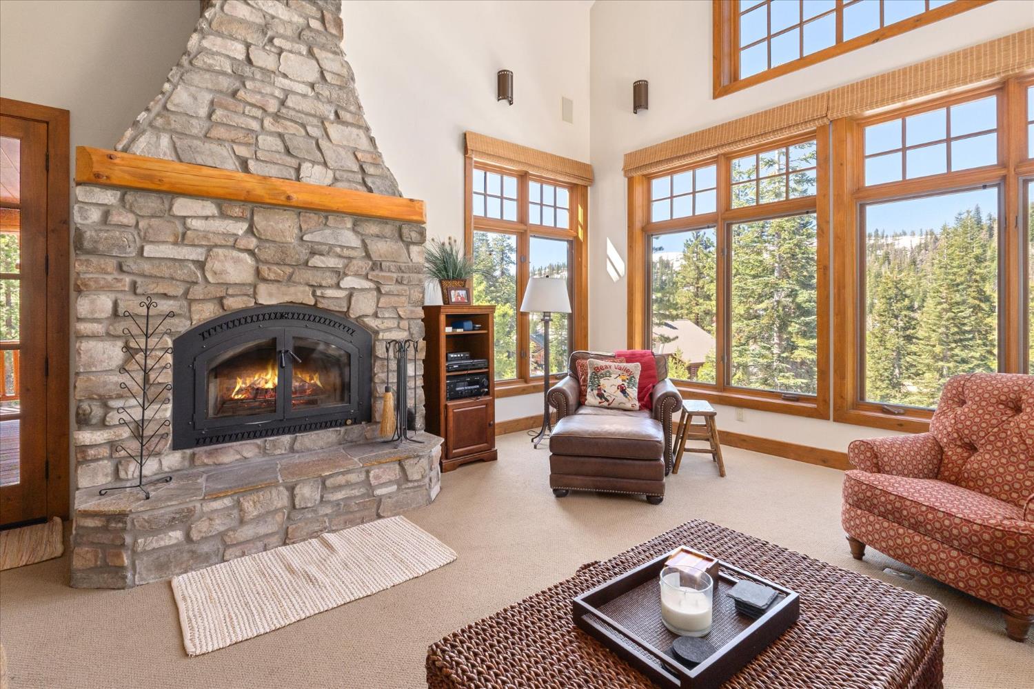 110 Flynn Road Bear Valley, CA 95223 - Photo 6 of 56 a living room with furniture a large window and a fireplace