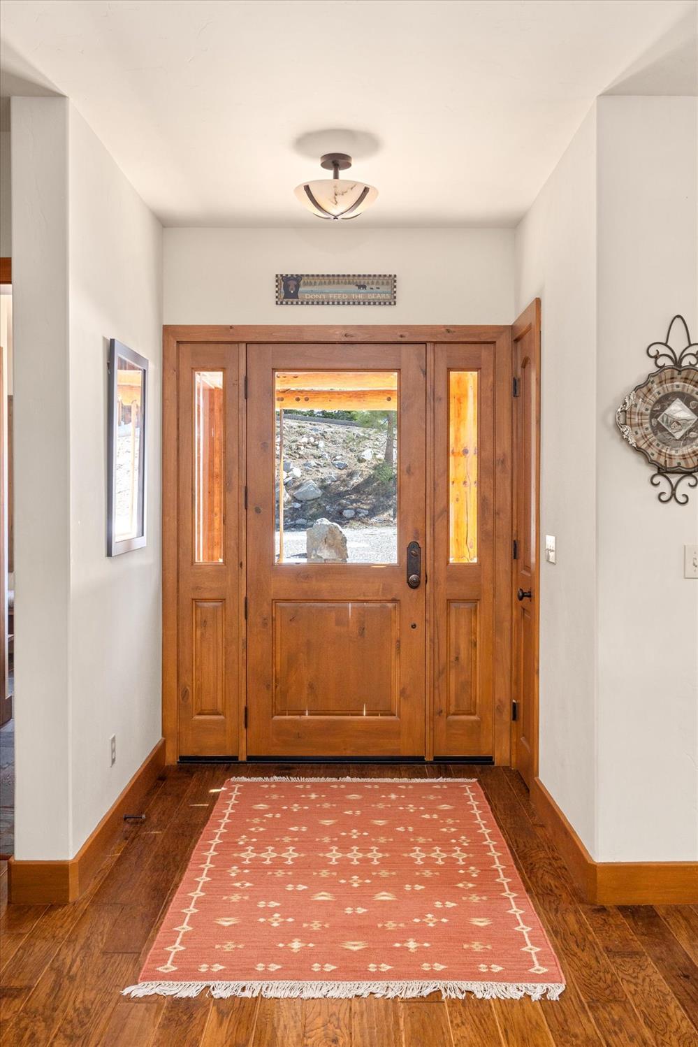 110 Flynn Road Bear Valley, CA 95223 - Photo 9 of 56 a view of an empty room with wooden floor and a window