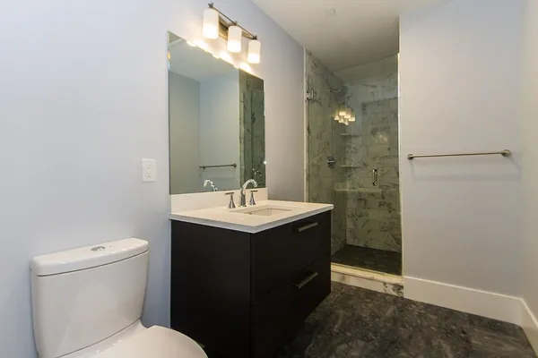 a bathroom with a sink toilet and shower