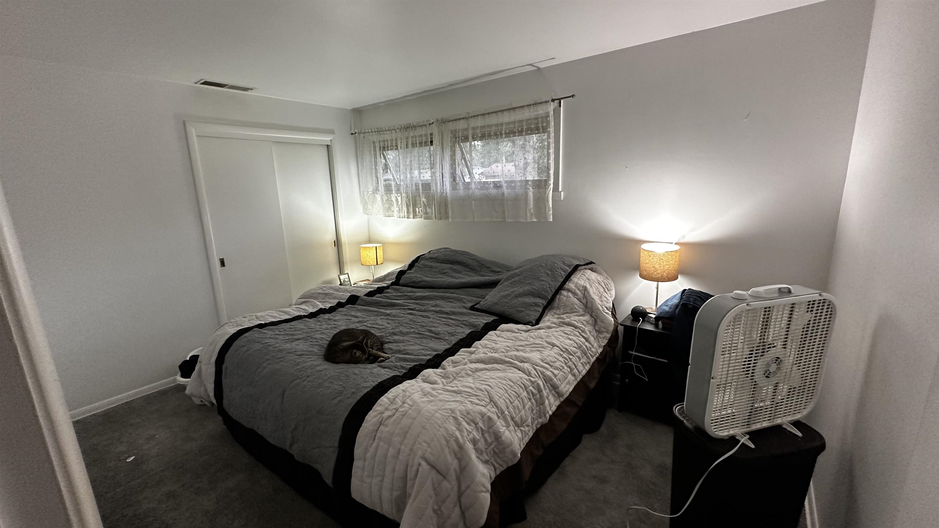 4721 Highcrest Road Rockford, IL 61107 - Photo 11 of 22 a bed sitting in a bedroom next to a window and lamp