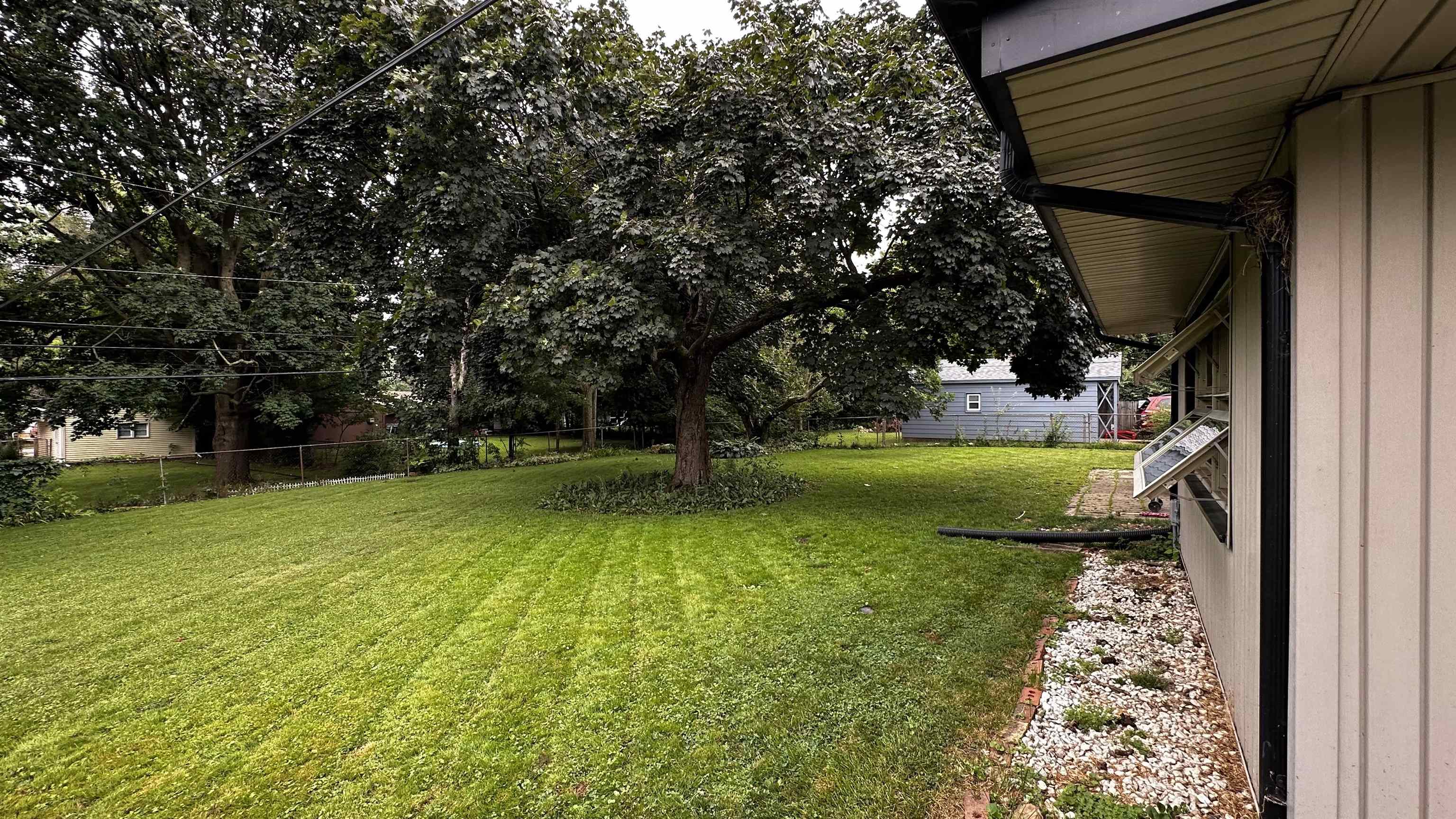 4721 Highcrest Road Rockford, IL 61107 - Photo 19 of 22 a view of yard with swimming pool and green space