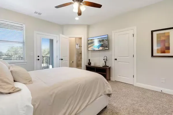 a bedroom with a bed and a chandelier