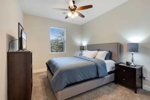 a bedroom with a bed and a flat tv screen