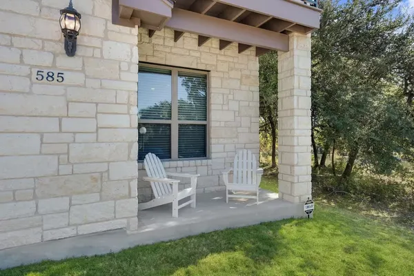 a view of front door of house with outdoor seating