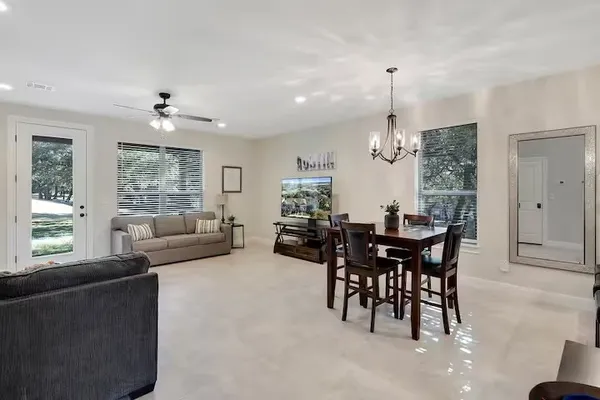 a living room with furniture dining table and a large window