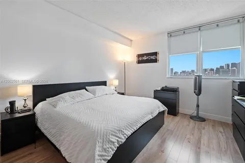 a bedroom with a bed and cabinets