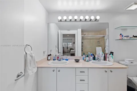 a bathroom with a double vanity sink and a mirror