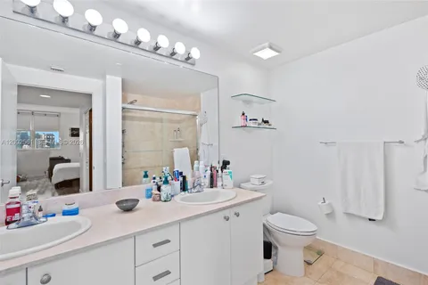 a bathroom with a sink double vanity and a mirror