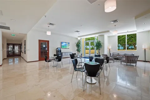 a living room with furniture and large windows