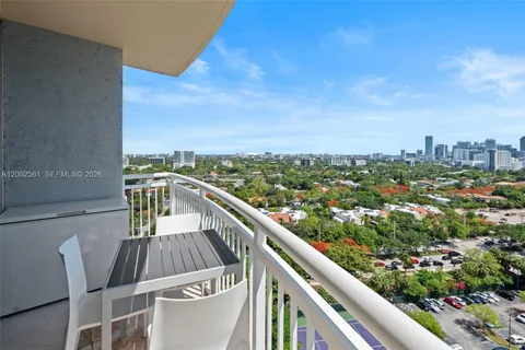a view of a balcony with two chairs and a table