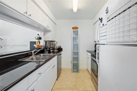 a kitchen with granite countertop a sink and stainless steel appliances