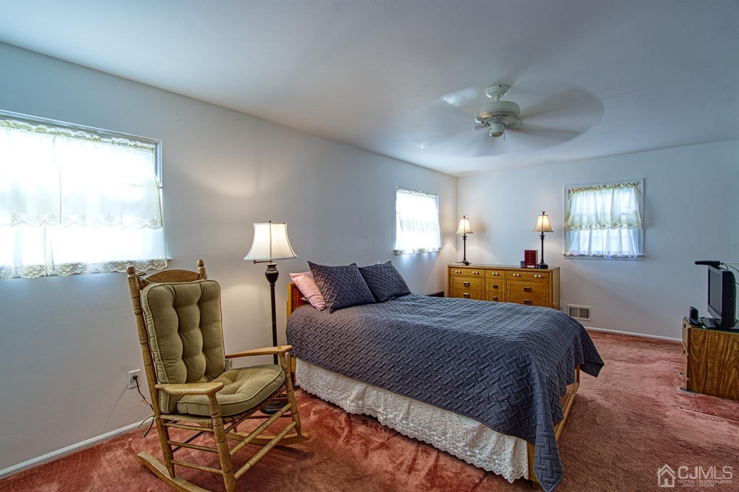 29 Surrey Road Somerset, NJ 08873 - Photo 13 of 18 a bedroom with a bed a chair and a large window