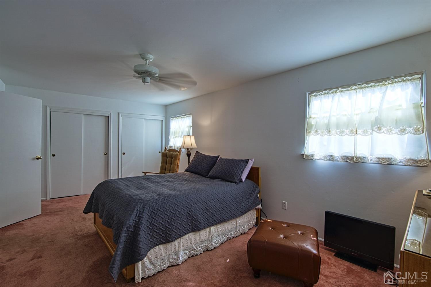29 Surrey Road Somerset, NJ 08873 - Photo 14 of 18 a bedroom with a bed and a chandelier