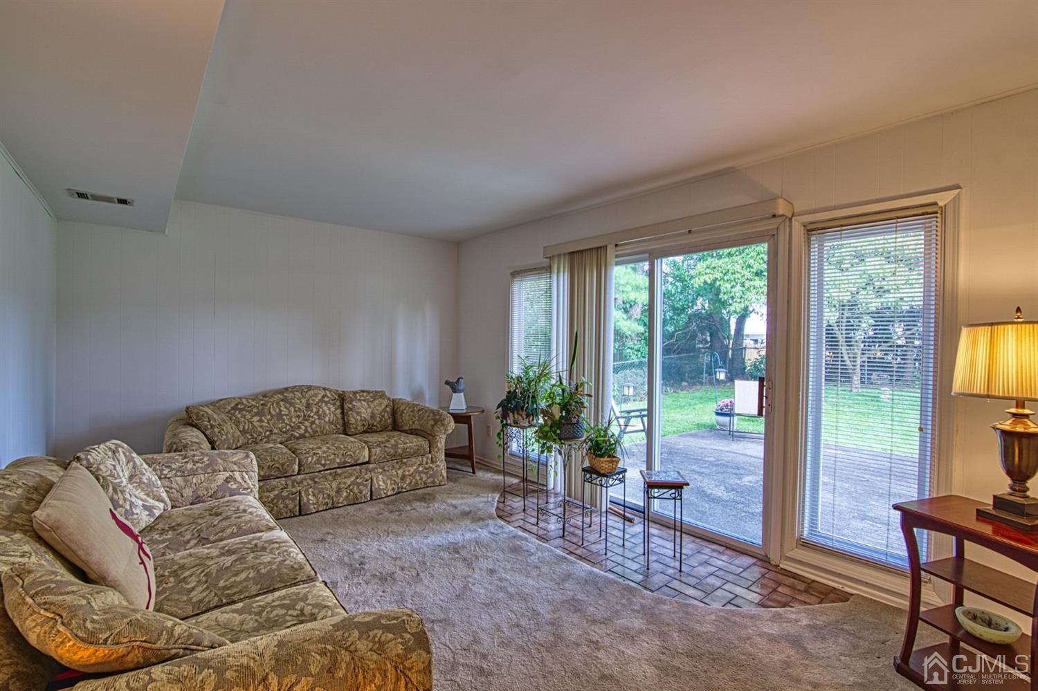 29 Surrey Road Somerset, NJ 08873 - Photo 8 of 18 a living room with furniture and a floor to ceiling window