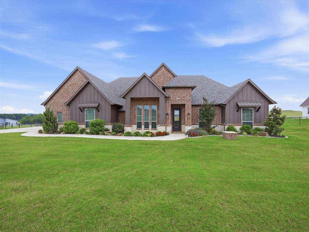 150 Quail Ridge Decatur, TX 76234 - Photo 1 of 32 a front view of a house with a yard