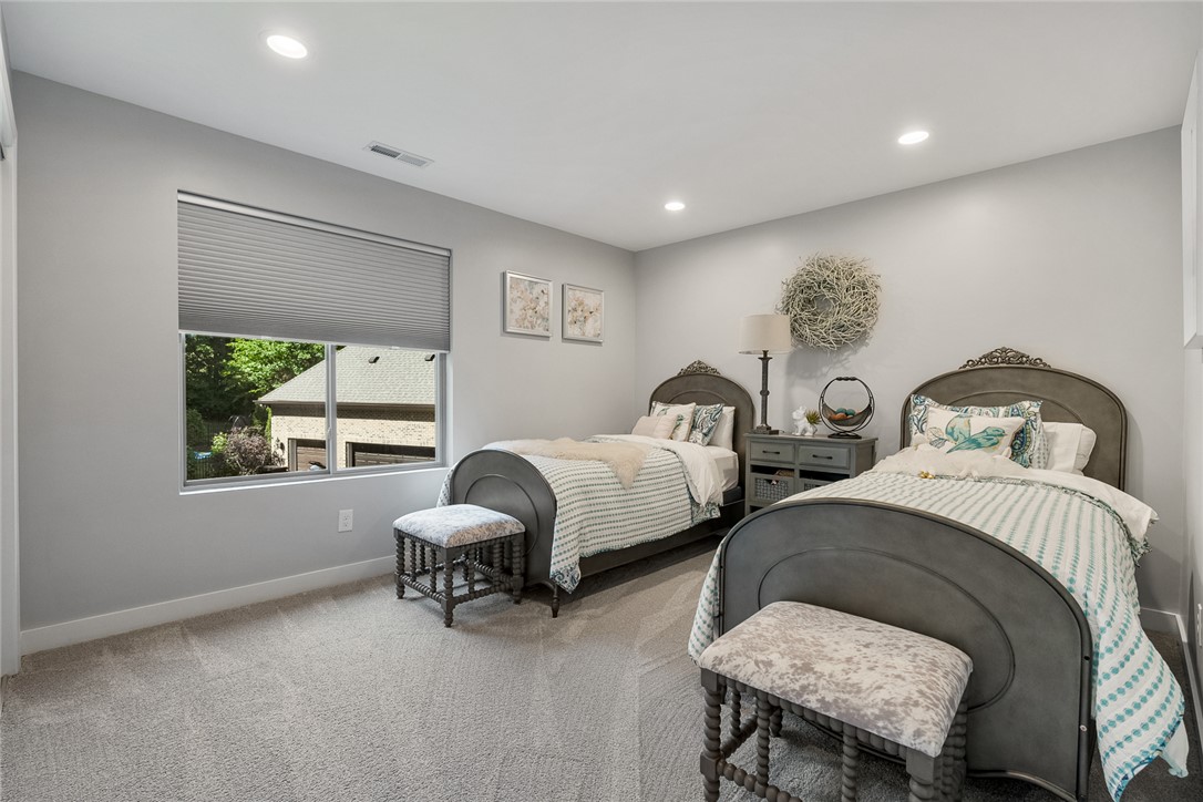 140 Turnberry Road Anderson, SC 29621 - Photo 26 of 44 This bright bedroom features ample natural light and plush carpeting, creating a comfortable and inviting atmosphere.