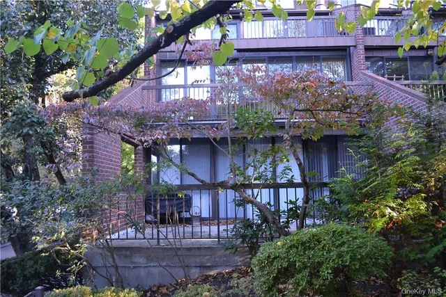 a view of a chairs and table in back of a house