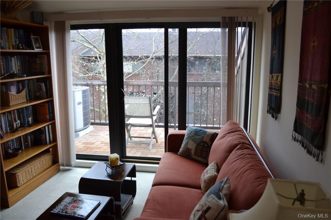 150 North Bedford Road, Unit 2F Chappaqua, NY 10514 - Photo 11 of 13 a living room with furniture and a flat screen tv