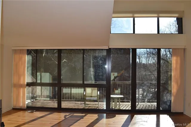 a view of a room with wooden floor and white walls