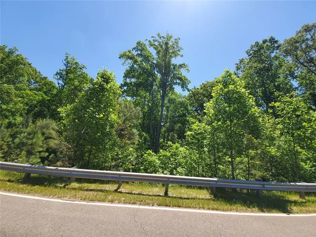 a view of outdoor space with swimming pool and trees in the background