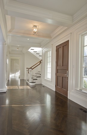 1 Green Lane Weston, MA 02493 - Photo 5 of 30 a view of a hallway with wooden floor and a living room