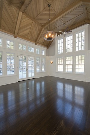 1 Green Lane Weston, MA 02493 - Photo 9 of 30 a view of an empty room with wooden floor and a floor to ceiling window