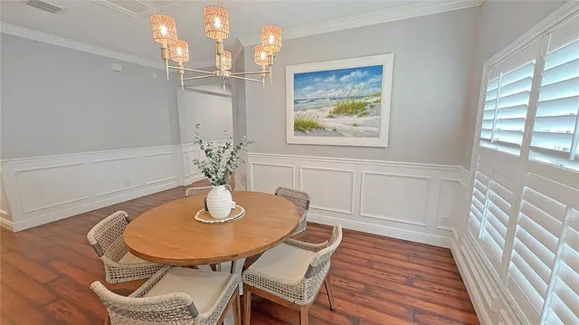 a dining room with furniture and wooden floor