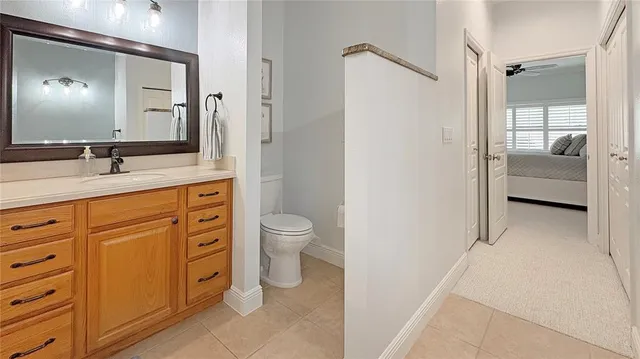 a spacious bathroom with a toilet sink and mirror