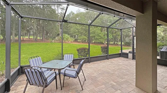 a view of a porch with furniture and yard