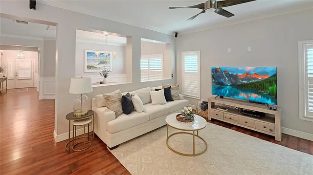 a living room with furniture a flat screen tv and a window